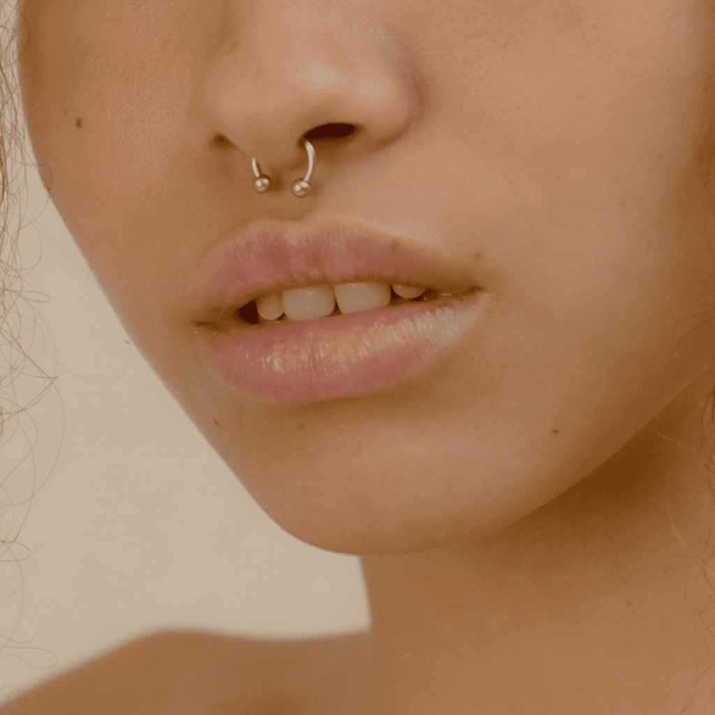nose piercing sticking out of nostril